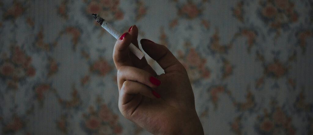 a hand holding a cigarette