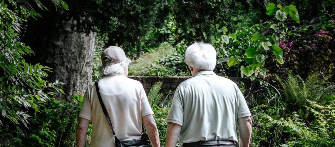 An elderly couple takes a walk